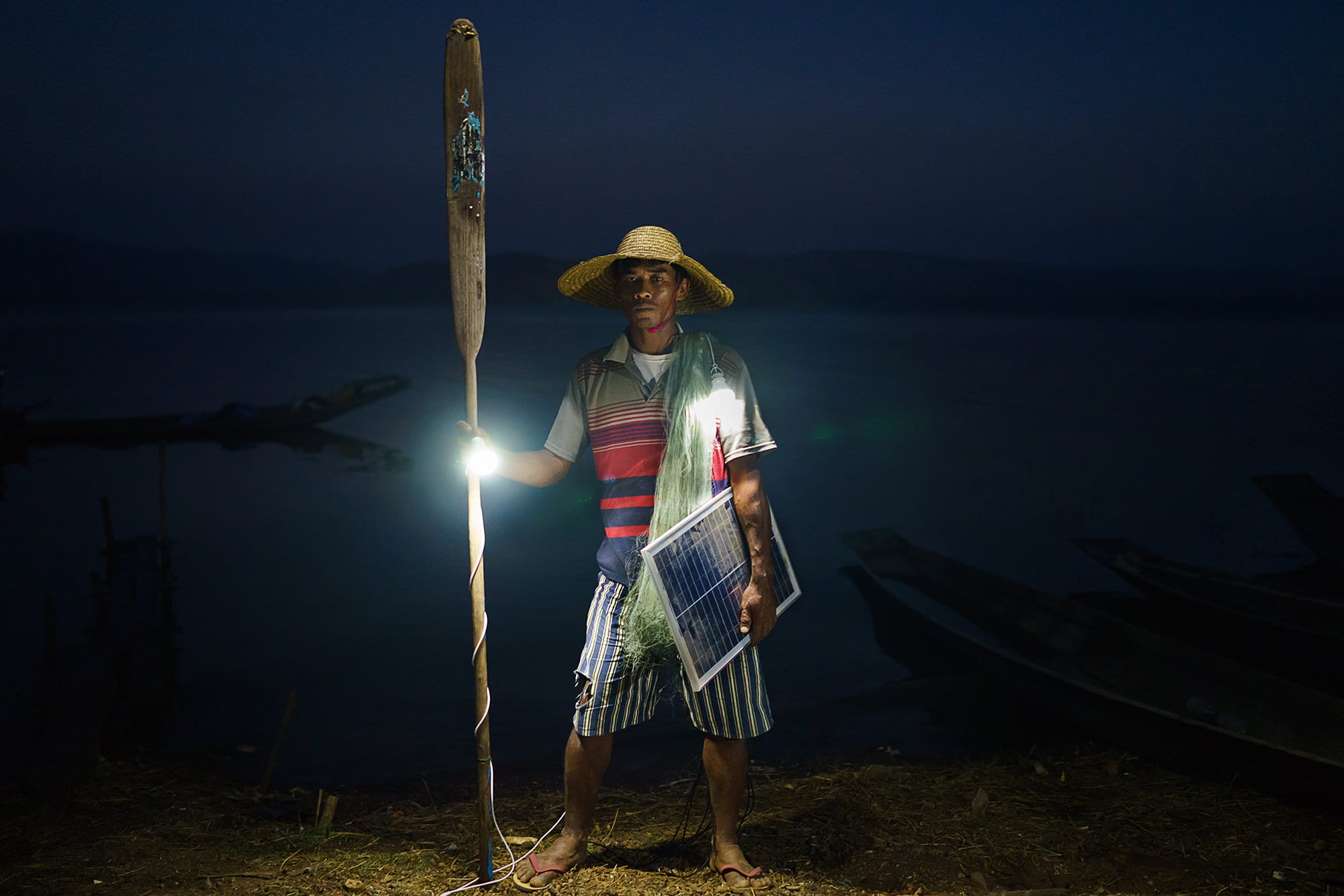 Ko Win Zaw Oo, fisherman and father of two by his boat.