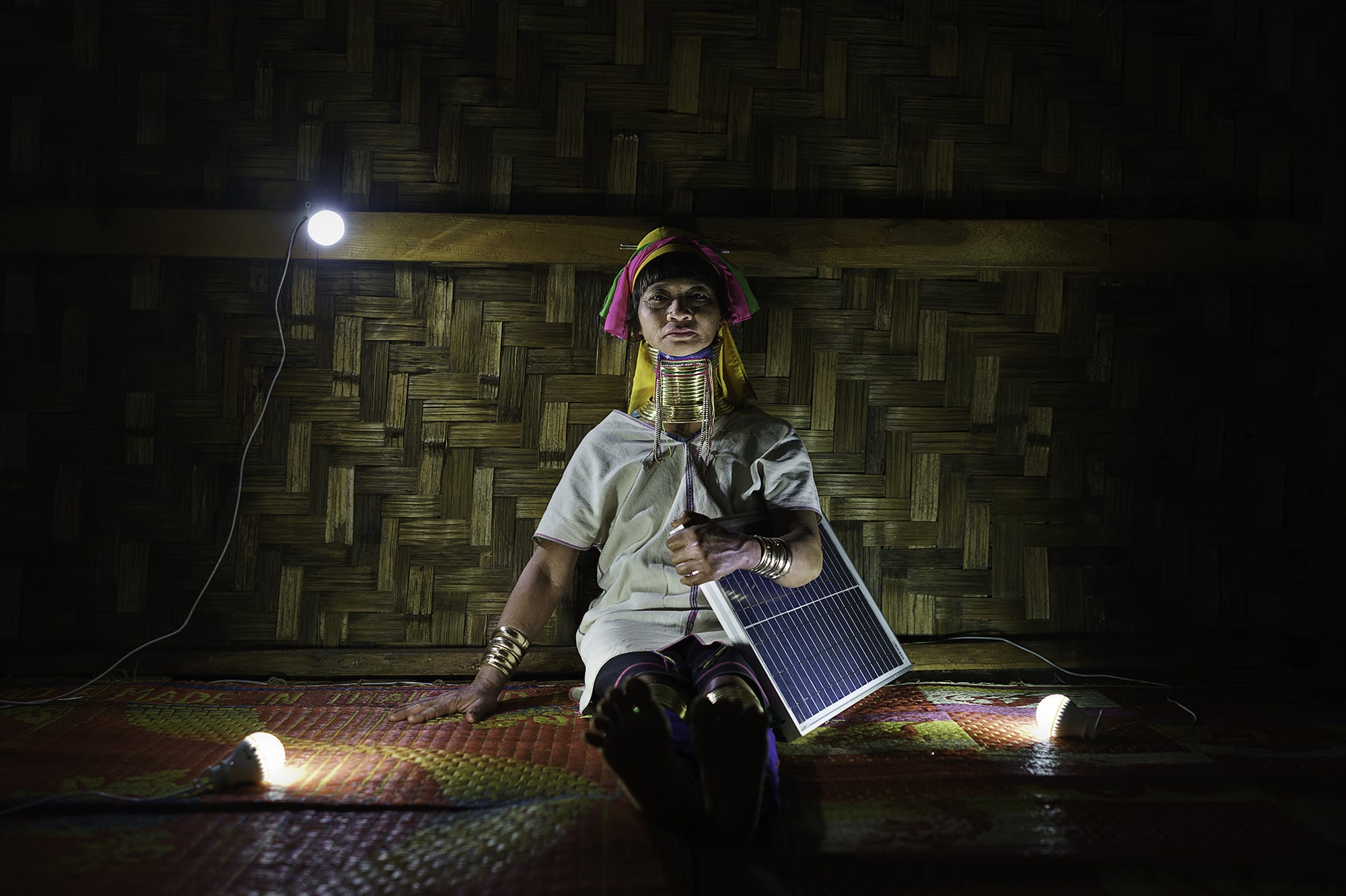 Daw Mu Nan, a Padaung farmer and mother of eight at her grandson's home.