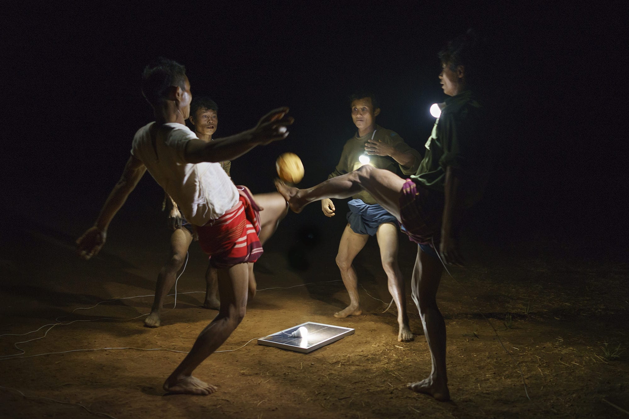 Men playing Chinlone, Myanmar's national sport on a field in Pa Dan Kho Village.