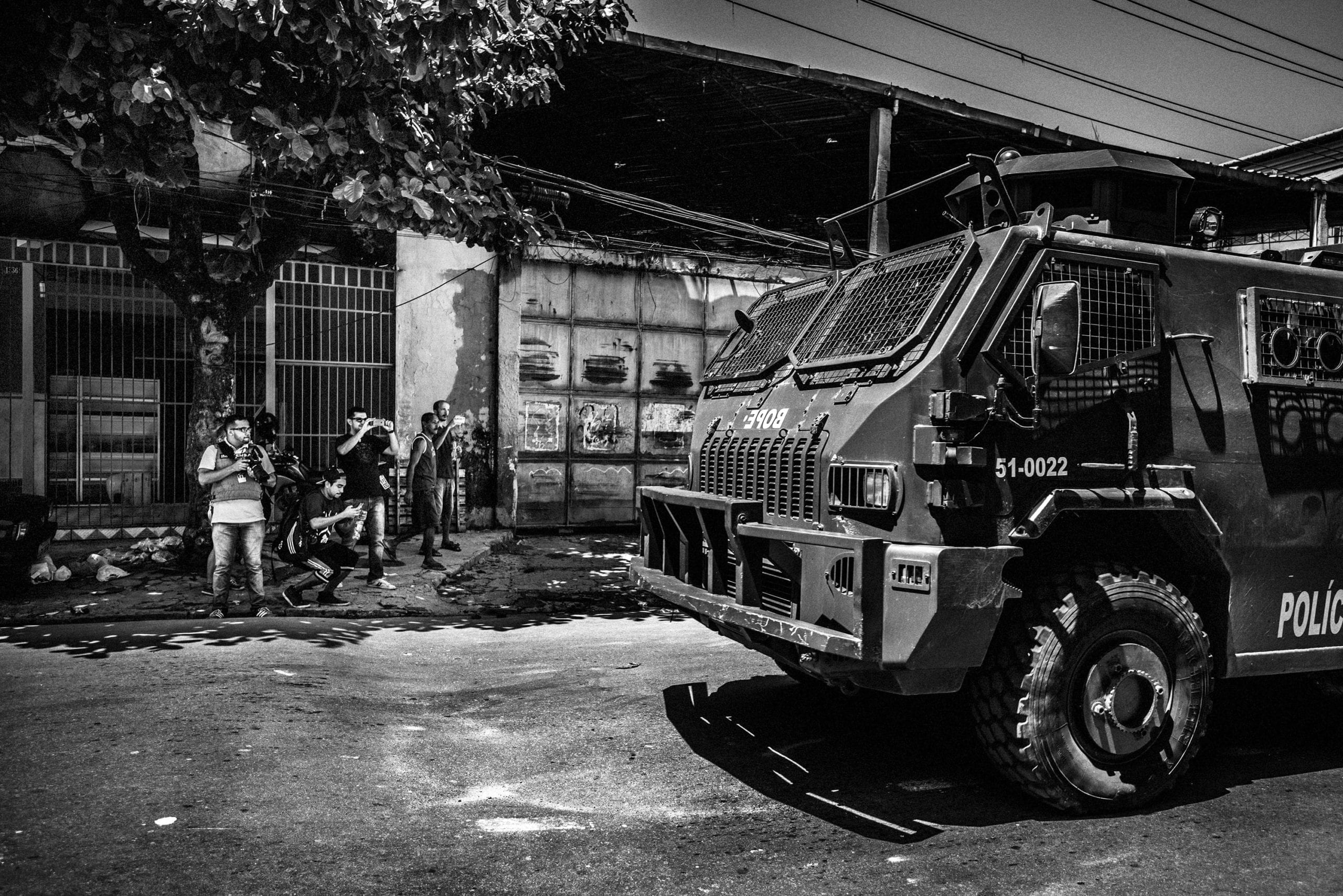 February 2015 - Rio de Janeiro, Brazil: Papo Reto collective members taking pictures and recording videos of the Special Police Forces (BOPE) tank-car patrolling in the streets of Vila Aliança, a favela near Complexo do Alemao. After a militar police cop kill a mototaxi driver in the streets of the favela, several cars and high caliber armed cops invaded the streets in alert of a possible confrontation with the gangs and from the population. © Sebastián Liste