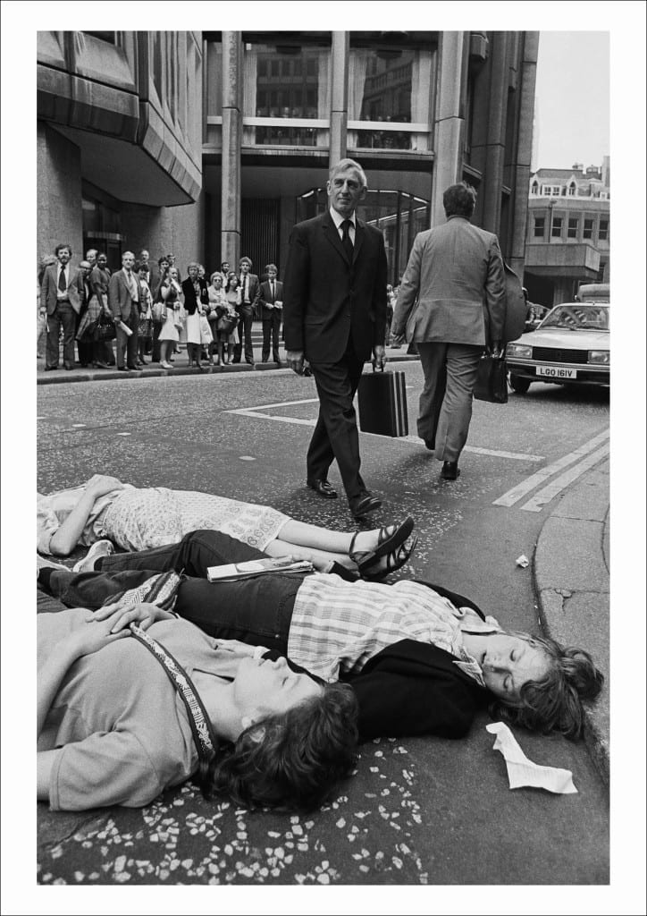 Greenham Common protesters stage a Die-in outside the Stock Exchange during the morning rush hour as U.S. President Reagan arrives in Britain, City of London (1982)