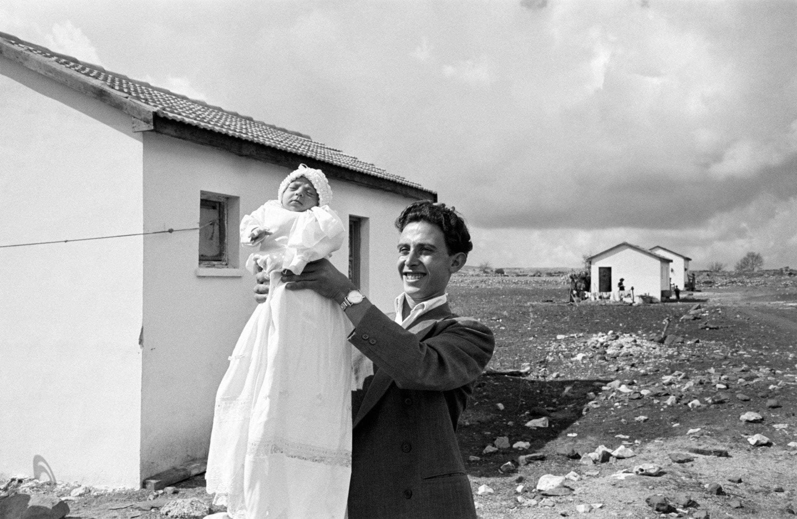 ISRAEL. 1951. First child (Miriam TRITO) born in the settlement of Alma. Eliezer TRITO is in charge of the pipeline construction work which is going to bring water from a source 3 miles away. He is seen here with the daughter he had with his wife Miriam.