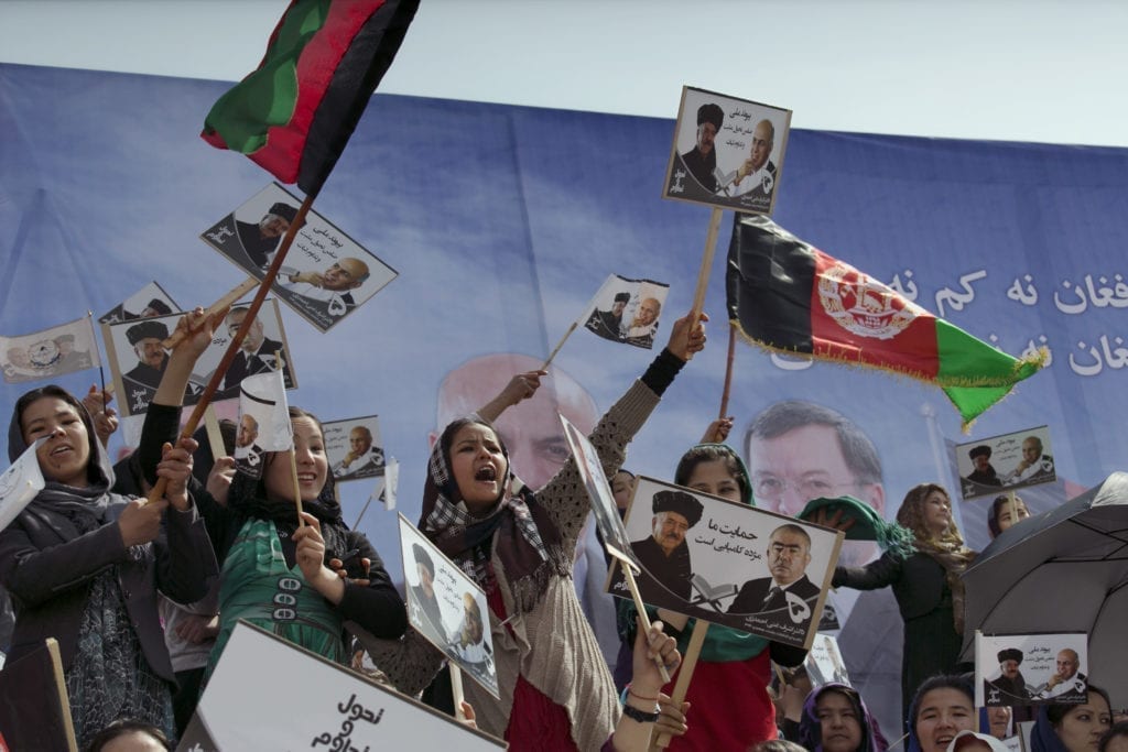 Young women cheer at rally