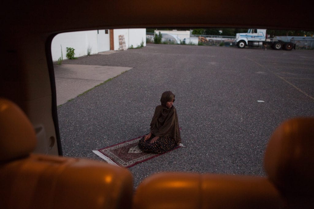 Fartun Mahamoud Abdi prays in the parking lot of a building where she will be opening a new daycare centre catering to Somali children in a suburb of Minneapolis. Ms. Abdi is also currently earning her PhD in radicalisation studies, focusing her research on the Somali community in Minneapolis. She says that instead of taking a top-down approach, law enforcement and community leaders need to listen directly to the Somali youth in order to understand the issues they are facing © Arthur Nazaryan