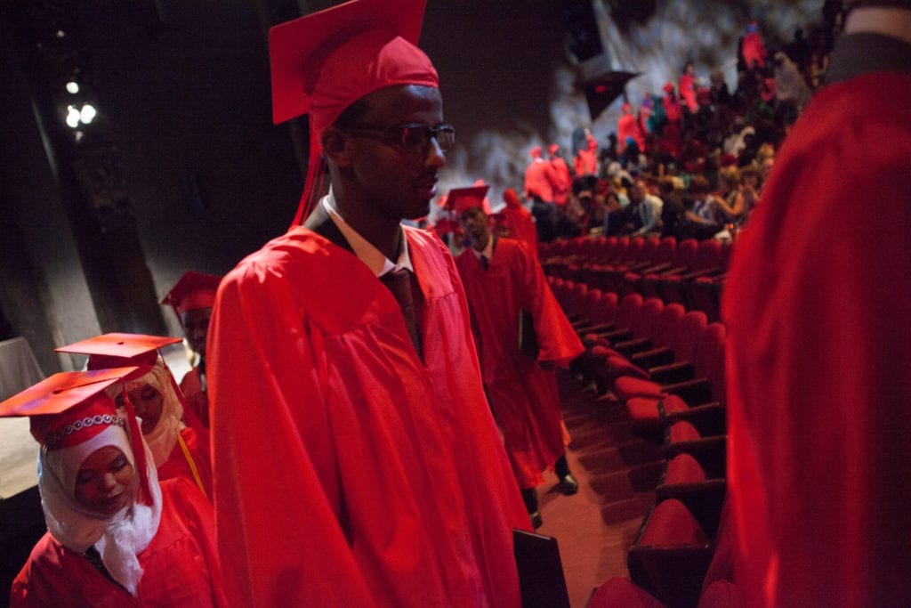 Graduating high school senior Mahamed Ahmed leaves the commencement ceremony for Linclon International High School, a charter school where the majority of students are Somali. The Twin Cities has a number of such charter schools, which many Somali parents prefer because they feel it will help preserve their kids' cultural identity © Arthur Nazaryan 