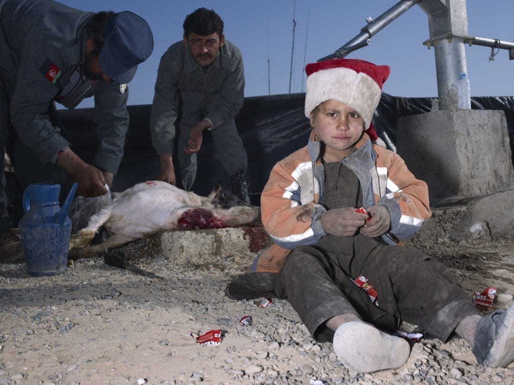 mark-neville-child-jacket-slaughtered-goat-sweets-painted-nails-xmas-day-helmand-2010-courtesy-mark-neville