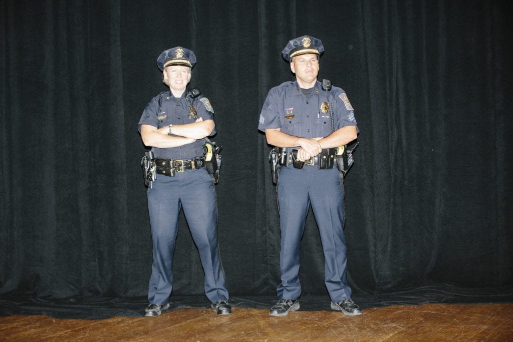 Police officers stand at the back of the room as former Florida governor and Republican presidential candidate Jeb Bush speaks with Americans for Prosperitys regional director Mark Lucas at the group's Road to Reform event at the Radisson Hotel in Manchester, New Hampshire, USA. Americans for Prosperity is a conservative political advocacy organization and the main vehicle for the Koch brothers' political advocacy.