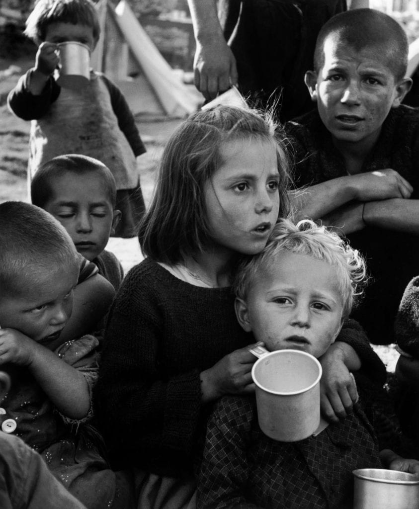 Refugees from the civil war areas. Waiting for this unfamiliar stuff, UNICEF milk (reconstituted from powdered milk) distributed for the first time at the refugee camp. Ioannina, Greece, 1948 © David "Chim" Seymour/Magnum Photos