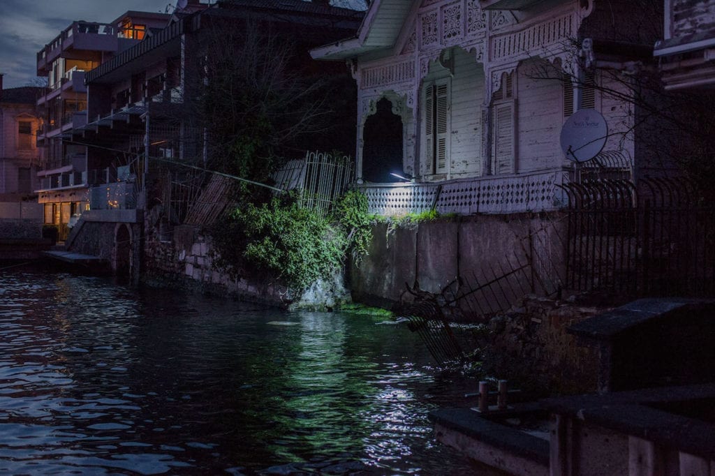 The security lights of a waterfront home on the Anatolian side of the Bosphorus illuminates the water as a Kanal D produced soap opera films in the neighbouring home. From the series The Parallel State © Guy Martin