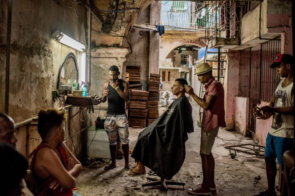 A weathered barber shop in Old Havana, Cuba on January 25, 2016. Cuba at times can feel like a nation abandoned. The aching disrepair of its cities, the untamed foliage of its countryside, the orphaned coastlines — a half-century of isolation has wrapped the country in decay. Yet few places in the world brim with as much life as Cuba, a contrast drawn sharper amid its faded grandeur. Image © Tomas Munita, The New York Times, first prize Daily Life - Stories