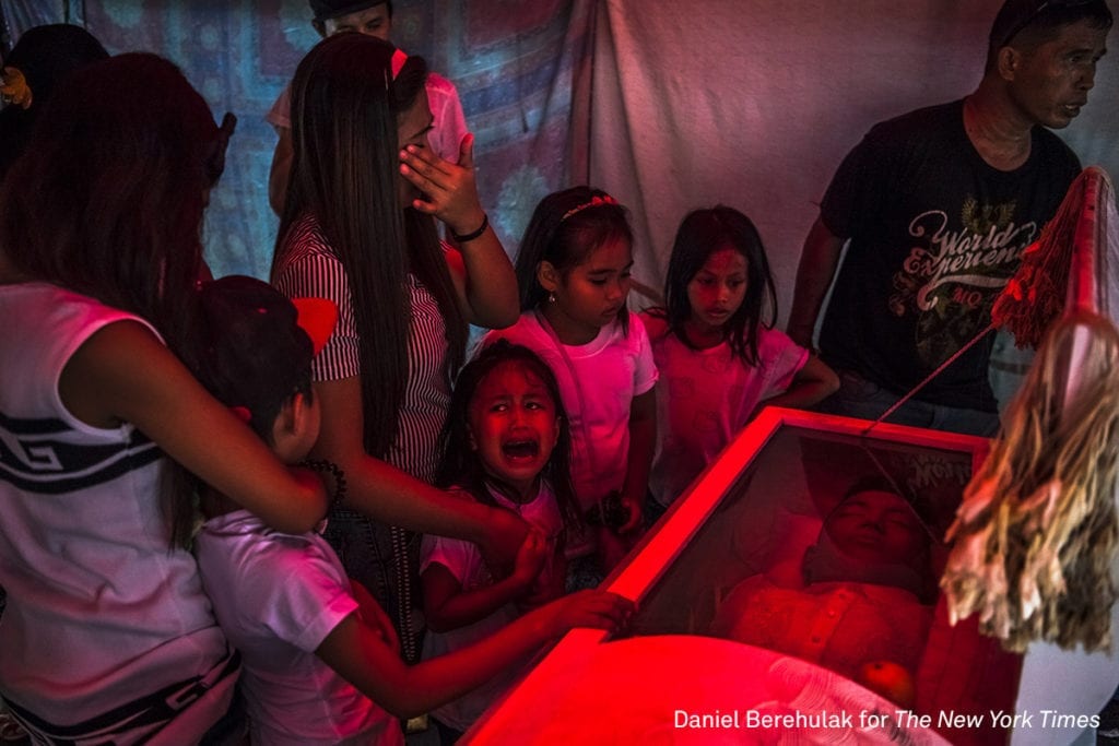 Six-year old Jimji cries in anguish as she screams "papa" before funeral parlor workers, move the body of her father, Jimboy Bolasa, from the wake at the start of the funeral to Navotas cemetery on October 9, 2016 in Manila, Philippines. Unidentified men abducted Mr. Bolasa and a neighborhood friends one night. Less than an hour later, their beaten bodies, with signs of torture and gunshot wounds were dumped under a nearby bridge. The police claim the men were alleged drug dealers while their family members say they had only surrendered themselves. President Rodrigo Duterte of the Philippines began his anti-drug campaign when he took office on June 30. Since then, over 2,000 people had been slain at the hands of the police alone. Beyond those killed in official drug operations, the Philippine National Police have counted more than 3,500 unsolved homicides since July 1. The victims, suspected users and pushers, are not afforded any semblance of due process, and are killed just about everywhere imaginable. Image © Daniel Berehulak/The New York Times, winner of the General News - Stories category