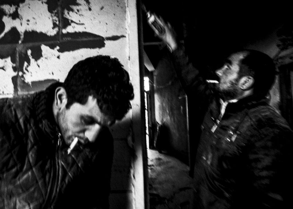 A Syrian refugee repairs a door in an apartment with a Kurdish repairman (left) in the Süleymaniye area, March 2015. From the series November is a beginning © Esa Ylijaasko 