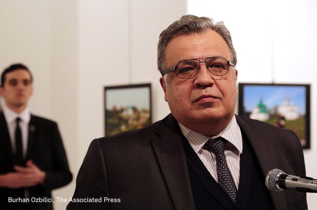 Andrei Karlov, the Russian ambassador to Turkey, speaks at an art gallery before being shot by Mevlut Mert Altintas, left, in Ankara, Turkey, Monday, Dec. 19, 2016. Image © AP Photo/Burhan Ozbilici. First prize, Spot News - Stories