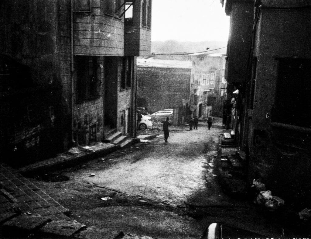 A boy runs on the street in Süleymaniye, Istanbul, Turkey, March 2015. From the series November is a beginning © Esa Ylijaasko