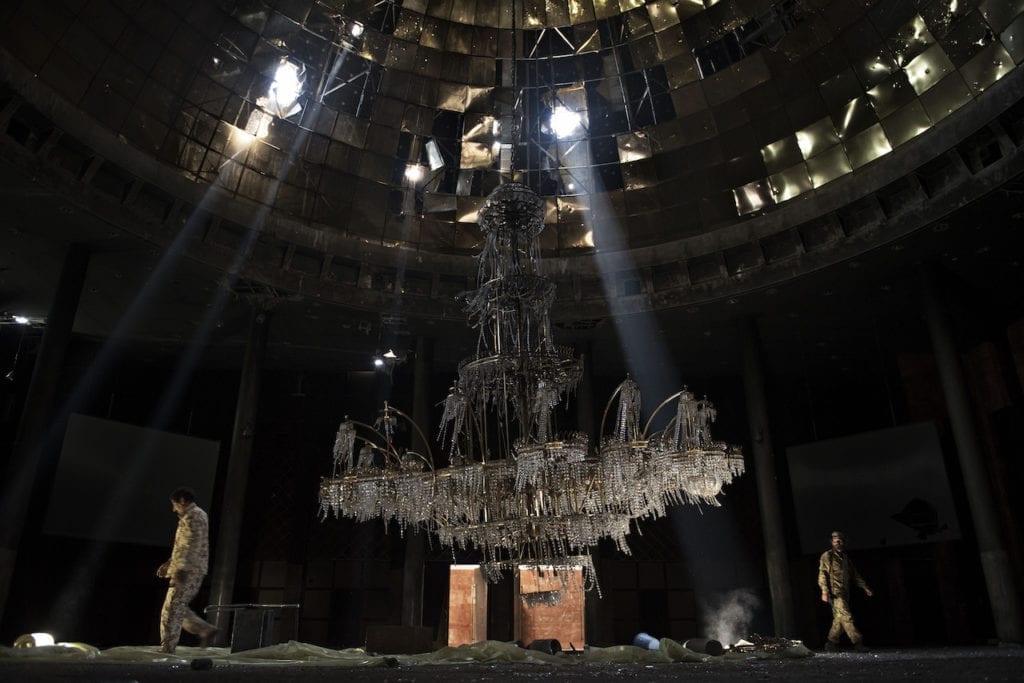 Fighters of the Libyan forces affiliated to the Tripoli government walk around the gigantic chandelier of the conference room in Ouagadougou congress complex Sirte, Libya, July 14, 2016. From the series We are taking no prisoners © Alessio Romenzi, Italy, shortlist, Professional, Current Affairs News category, 2017 Sony World Photography Awards