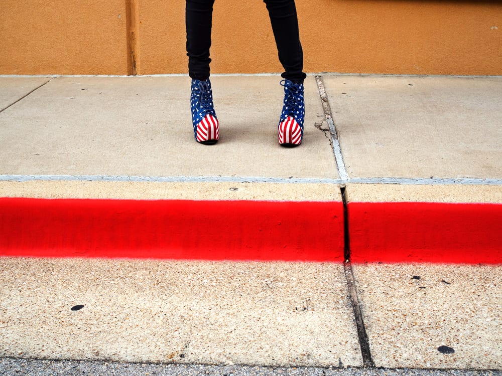 Patriotic footwear worn by Chloe on her way to work in Southlake. Southlake is an affluent city located north-west of Dallas in the U.S state of Texas with a population of arond 26,5700. Southlake was named in 2014 as one of TIME magazines top 10 richest towns in America a and is known for public schools, Southlake Town Square, its wealth, Gateway Church and Carroll High School's 8-time state champion football team. Dallas is a major city in Texas and is the largest urban center of the fourth most populous metropolitan area in the United States. The city ranks ninth in the U.S. and third in Texas after Houston and San Antonio. The city's prominence arose from its historical importance as a center for the oil and cotton industries, and its position along numerous railroad lines. For two weeks in the summer of 2015, photographer Peter Dench visited Dallas to document the metroplex in his epic reportage, DENCH DOES DALLAS. Photographed using an Olympus E-M5 Mark II ©Peter Dench/Getty Images Reportage