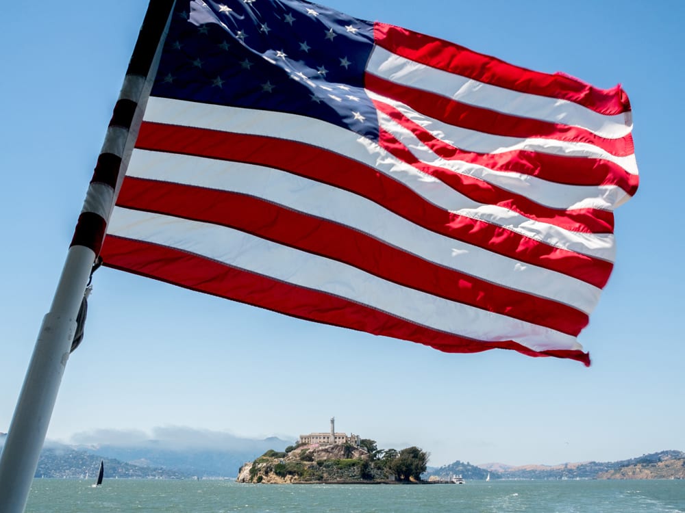 Alcatraz Island is located in the San Francisco Bay, 1.25 miles (2.01 km) offshore from San Francisco. The small island was developed with facilities for a lighthouse, a military fortification, a military prison (1868), and a federal prison from 1933 until 1963. Beginning in November 1969, the island was occupied for more than 19 months by a group of aboriginal people from San Francisco who were part of a wave of Native activism across the nation with public protests through the 1970s. In 1972, Alcatraz became a national recreation area and received designation as a National Historic Landmark in 1986. San Francisco is the cultural, commercial, and financial center of Northern California, USA. San Francisco encompasses a land area of about 46.9 square miles (121 km2) on the northern end of the San Francisco Peninsula, which makes it the smallest county in the state. It has a density of about 18,451 people per square mile (7,124 people per km2), making it the most densely settled large city (population greater than 200,000) in the state of California and the second-most densely populated major city in the United States after New York City. @Peter Dench/Getty Images Reportage