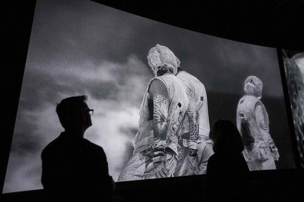 Installation shot of Incoming by Richard Mosse in collaboration with Trevor Tweeten and Ben Frost at The Curve, Barbican. Image © Tristan Fewings/Getty Images for Barbican Art Gallery