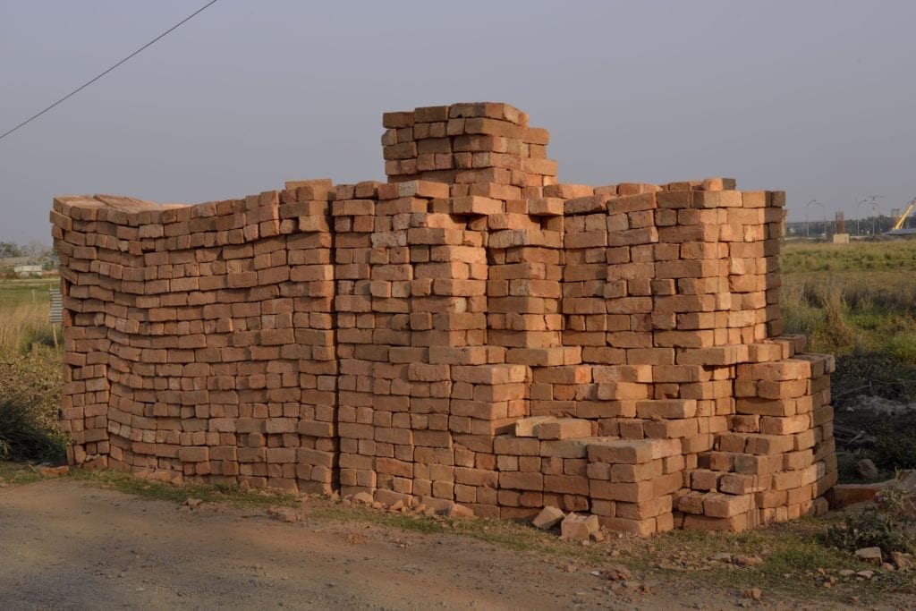 Bricks dating back to 7500 BC have been found at Tell Aswad in the upper Tigris region of what is now modern Syria. In Exodus 1:14; 5:4-19 we are told that the Egyptians “came to dread the Israelites and worked them ruthlessly. They made their lives bitter with harsh labor in bricks and mortar.” Straw and sand were added to mud and kneaded by foot for days before being set in molds. Union Solidarity International has been campaigning against “blood bricks’ in India since 2012. In the words of Andrew Brody, “its modern day slavery. Entire families of men, women, and children are working for a pittance, up to 16 hours a day in terrible conditions. There are horrific abuses of minimum wage rates and health and safety regulations, and it’s often bonded labor, so they can’t escape.” Bricks, Outskirts of Kolkuta, India, March, 2014 © Joel Sternfeld. Image courtesy of Luhring Augustine and Beetles+Huxley