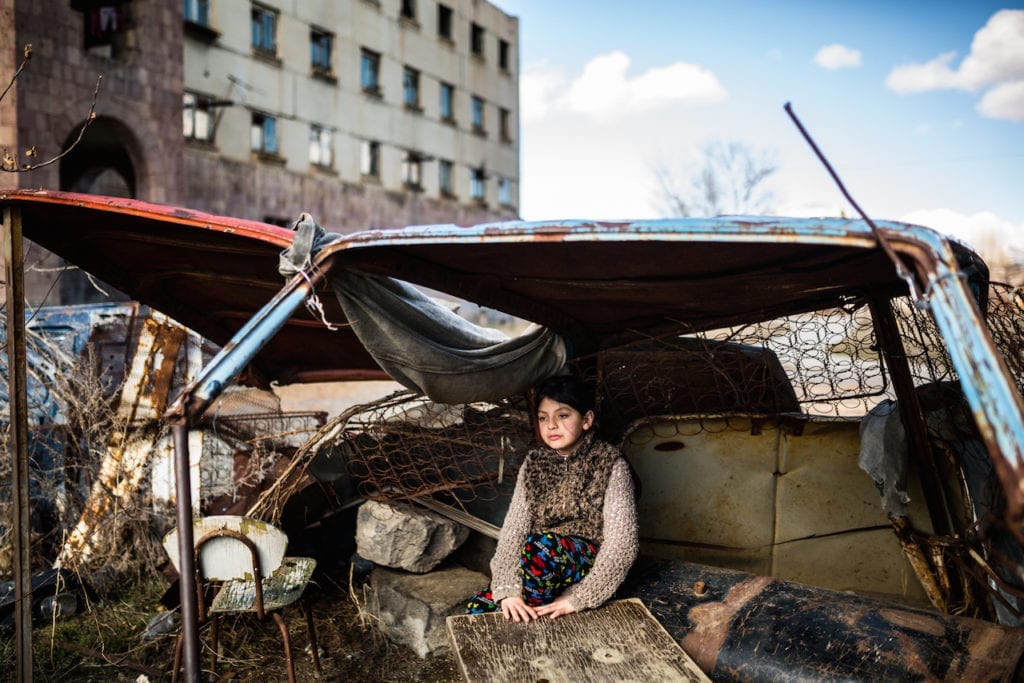 Syuzanna, nine, sitting in a “shelter” made of rusty old car parts. Ten days ago Syuzanna's father committed suicide, people say, because of debt. In 1988, a 7.0 Richter-scale earthquake struck northern Armenia. The quake killed at least 25,000 people in the region. Thousands more were maimed and hundreds of thousands left homeless. Gyumri, Armenia’s second largest city bore much of the damage. Large-scale war by the early 1990s, the collapse of the Soviet Union, an energy shortage, and a blockade that left landlocked Armenia with just two open borders, contributed to exacerbating the region's already prevalent social and economic problems. A quarter of a century later, Gyumri has the country’s highest poverty rate at 47.7%. The city has lost nearly half of its population since 1988, due in part to the migration of the labour force. A few thousand families are still living in makeshift shelters, waiting for help. From the series Inhabitants of the Empty © Yulia Grigoryants, Armenia, shortlist, Professional, Daily Life, 2017 Sony World Photography Awards