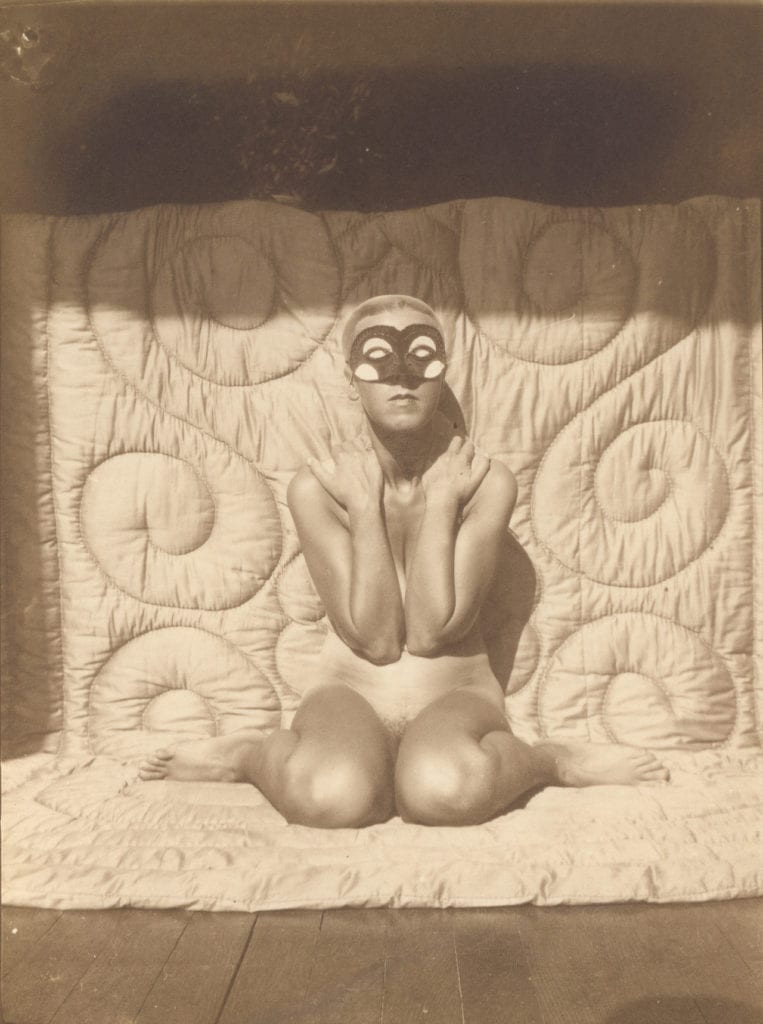 Self-portrait (kneeling, naked, with mask) by Claude Cahun, c.1928 © Jersey Heritage