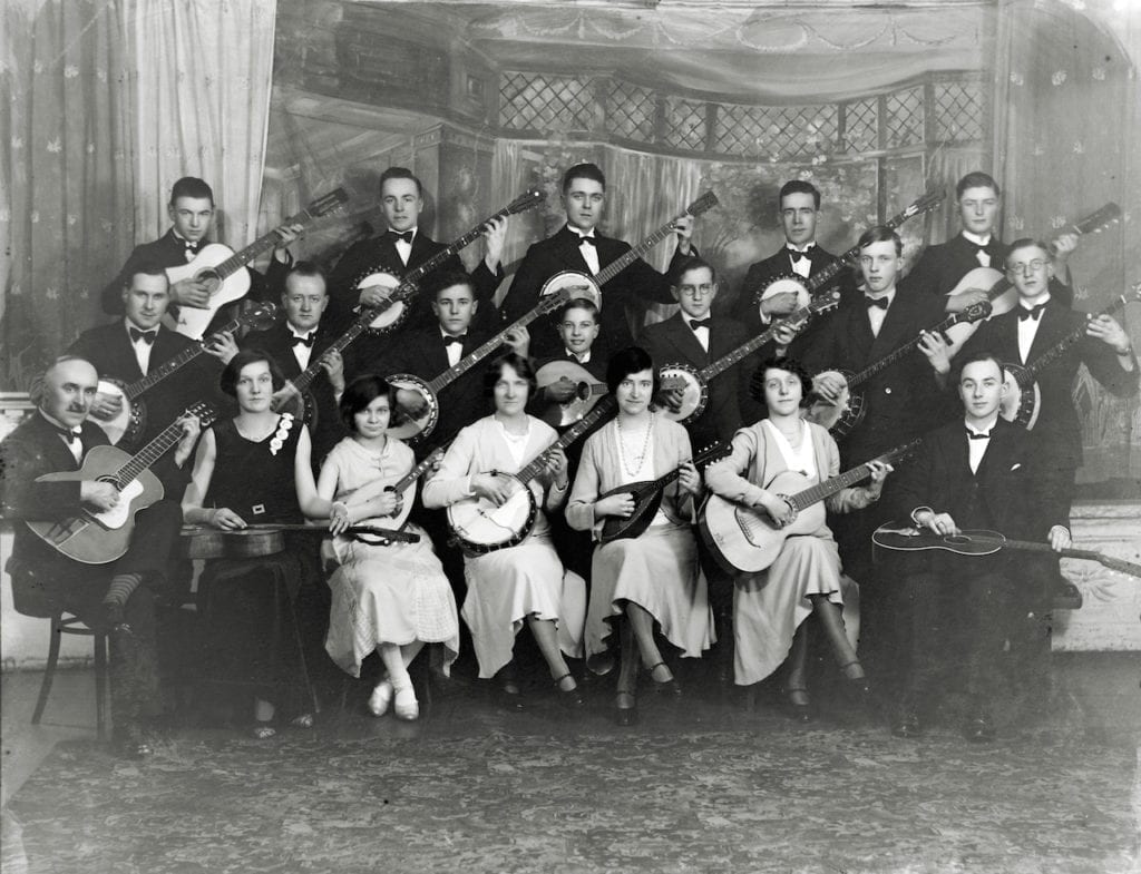 Musical group in front of a painted studio backdrop at WW Winter studio, 1920s © WW Winter Ltd