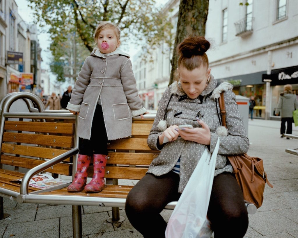 Girl with pink wellies and pacifier, Cardiff. From the series My Favourite Colour Was Yellow © Kirsty MacKay