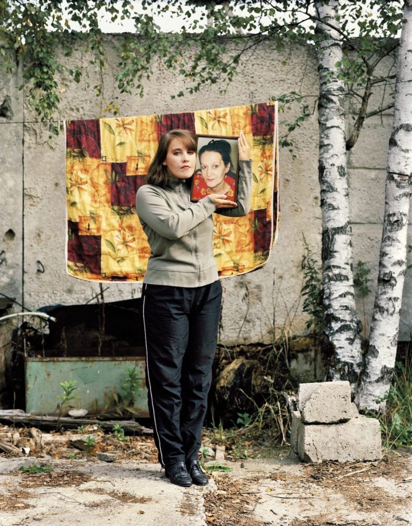 Margaret Kiseleva, holding a photograph of her mother, Ludmila, KrioRus facility, Alabushevo, Moscow. September 2010. From The Prospect of Immortality © Murray Ballard