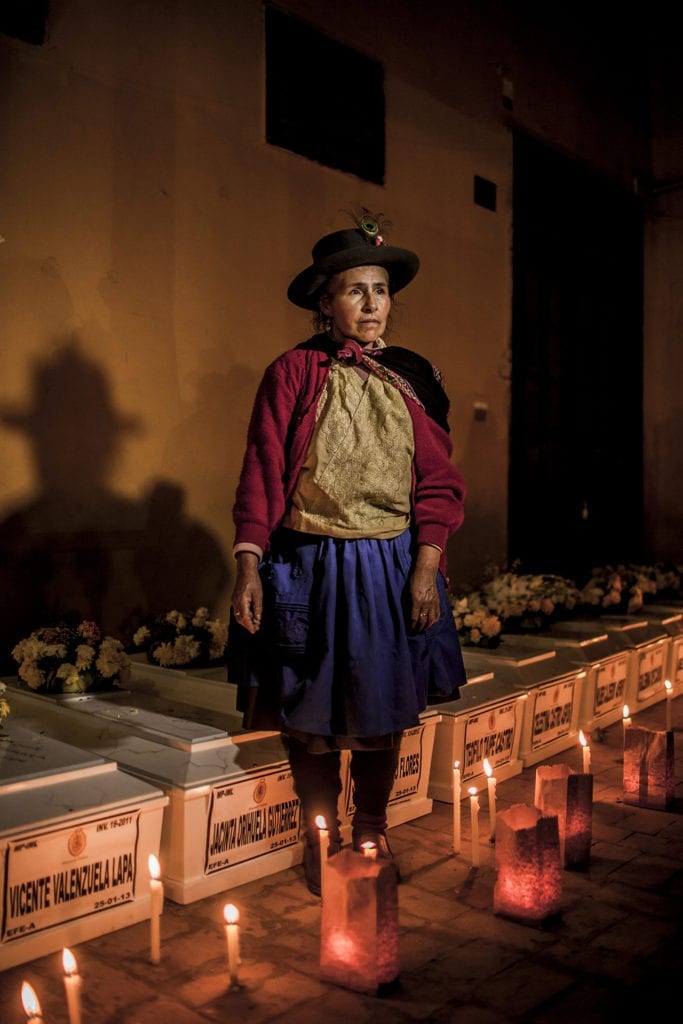 Alejandrina Valenzuela in front of the coffins of her parents; during the memorial service for 74 people from the district of Chungui; in Ayacucho; in the municipal building of Huamanga. © Musuk Nolte / Magnum Foundation