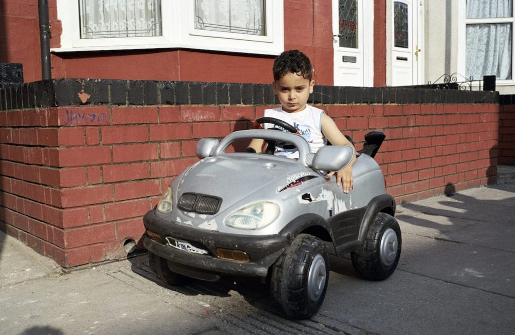 Boy with BMW toy car from the series You Get Me?, 2009 © Mahtab Hussain, courtesy the artist
