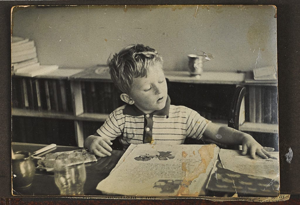 Justin, aged about 5, reading Ba Ba the Elephant at home in Richmond. From the series Big Brother © Louis Quail