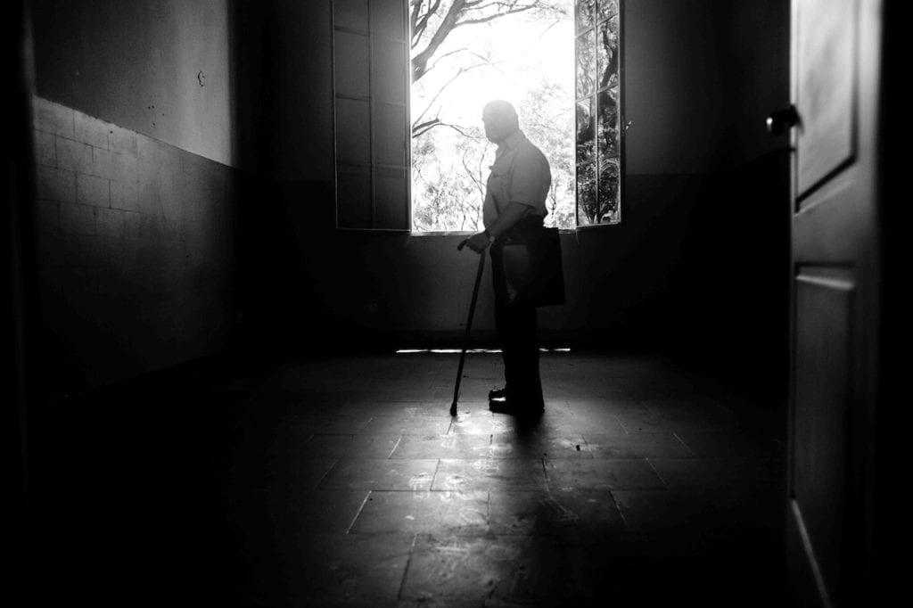 Victor Basterra was kidnapped and brutally tortured at the ESMA. He has been photographed into the office of Miguel Adolfo Donda, one of the most brutal torturers of the barracks, Buenos Aires, Argentina, 2008 © Giancarlo Ceraudo, courtesy of the artist