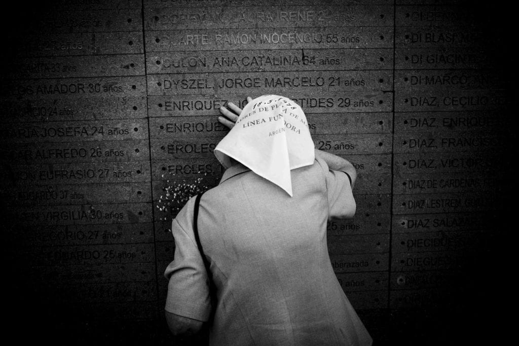 One of the Mothers of Plaza de Mayo cries on her son’s name inscribed on the wall of the Park of Memory, the Monument to the Victims of State Terrorism located along the coastline of the Río de la Plata river. Buenos Aires, Argentina, 2007 © Giancarlo Ceraudo, courtesy of the artist