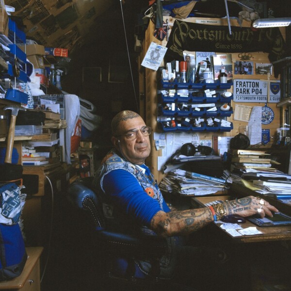 John Portsmouth Football Club sat at his desk