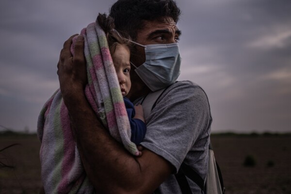 Asylum-seeking Migrant Father Cradles Daughter